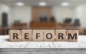 Reform sign on a desk with a blurry background of a court room