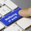 'Wellbeing at work' key being pressed on keyboard