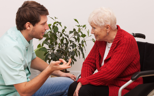 Social worker talking to older woman