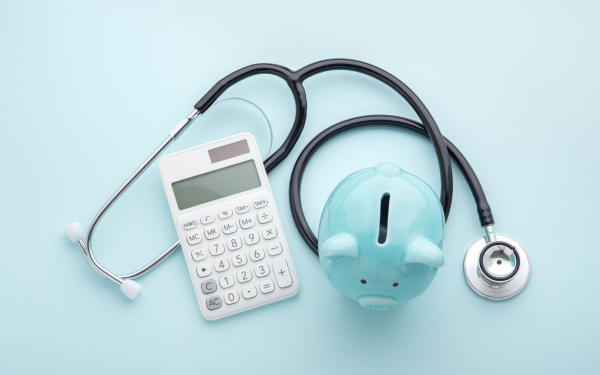 Stethoscope, calculator and piggy bank image