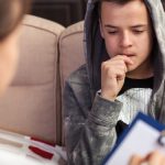 Social worker counselling young man
