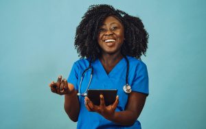 Nurse practitioner doctor with tablet and stethoscope laughing