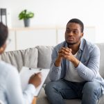 Young black man receiving a mental health assessment