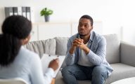 Young black man receiving a mental health assessment