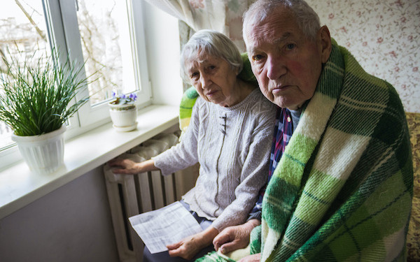 Image of elderly couple with energy bill (credit: Solarisys / Adobe Stock)