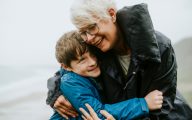 Happy grandmother hugging her grandson