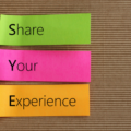 Post-it writing 'Share Your Experience'