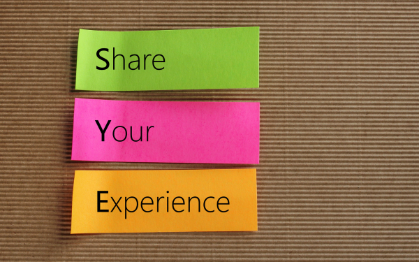 Post-it writing 'Share Your Experience'