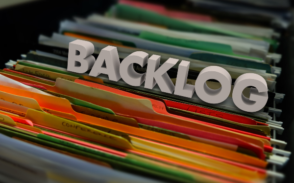 Files in a cabinet with the word 'backlog' on it