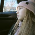 Girl looking pensive on car journey
