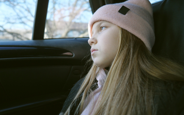 Girl looking pensive on car journey
