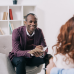 social worker speaking to two teenagers during a visit