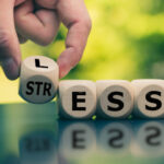 Having less stress or being stress-less. Hand turns a cube and changes the word "STRESS" to "LESS".