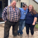 Paul is flanked by Shared Lives carers Maurice (left) and Simone (right)