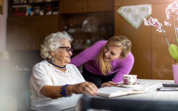 A care worker talking to an older person