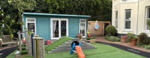 View of the group work lodge, children's play area and garden at Jasmine Mother's Recovery