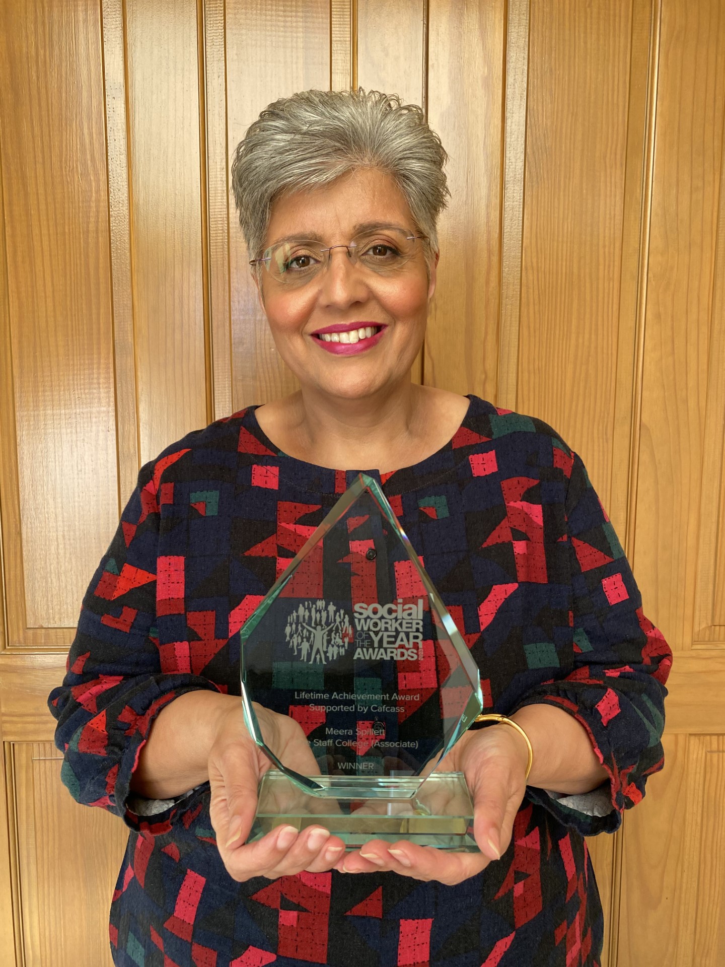 Meera Spillett holding her lifetime achievement award