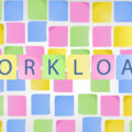 Post-it notes on a wall with the word 'workload' in the foreground