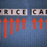 The word price cap written in blocks with red arrows pointing up to it