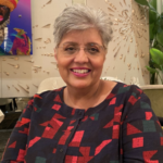 Photo of Meera Spillett smiling at the camera