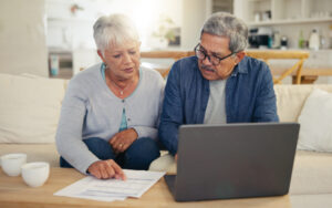 An older couple poring over their finances