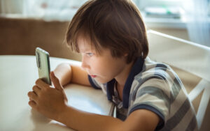 Boy staring intensely at phone
