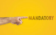 A man's pointing hand next to the inscription mandatory on yellow background