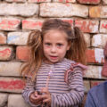 Picture of girl and her dad in front of a wall