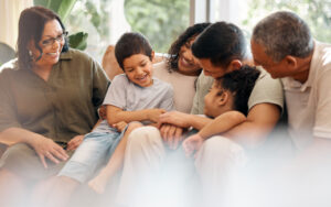 A family sitting on a sofa together laughing