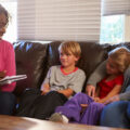 Social Worker Talking To Mother And Children At Home