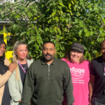 a group of social workers looking at the camera in front of a green background