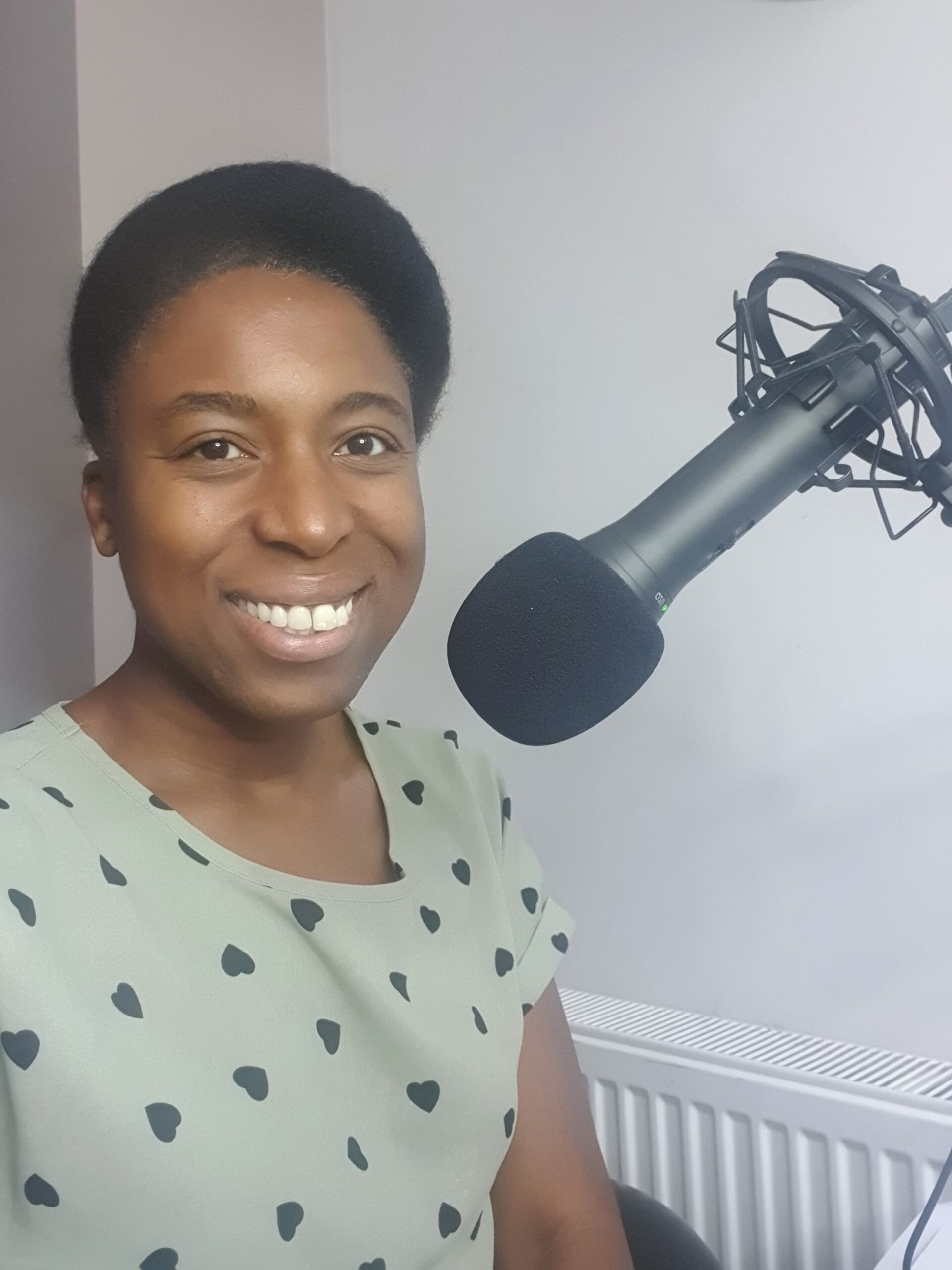 Janet Ayoola smiling in front of a microphone