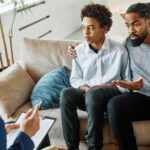 Father with his teenage son at meeting with social worker,