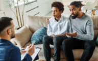 Father with his teenage son at meeting with social worker,