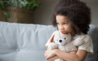 Sad girl hugging a teddy