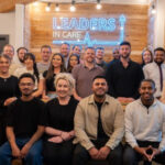 A group of staff from the organisation Leaders in Care in a group photograph