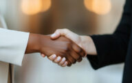 Two women shaking hands