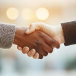Two women shaking hands