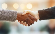 Two women shaking hands