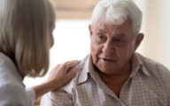 Social worker comforting older man