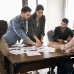 A group of colleagues discussing statistics in a meeting