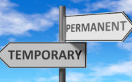 A road sign with two boards, one that reads 'temporary' and the other 'permanent'