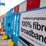 Roadworks on a street with a sign that reads installation in progress_ full fibre broadband'