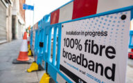 Roadworks on a street with a sign that reads installation in progress_ full fibre broadband'