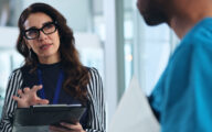 Social worker in stand-up meeting with doctor