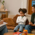 Social worker talking to father and upset daughter