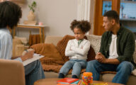 Social worker talking to father and upset daughter