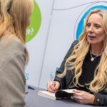 Jenny Molloy, who writes under the pseudonym Hope Daniels, signing her book 'This Isn't Love' at Community Care Live 2024.