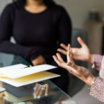Independent reviewer interviewing a social worker for a case review