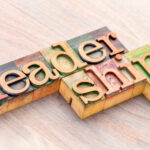 The word 'leadership' spelt out on a wooden letterpress sat on a table